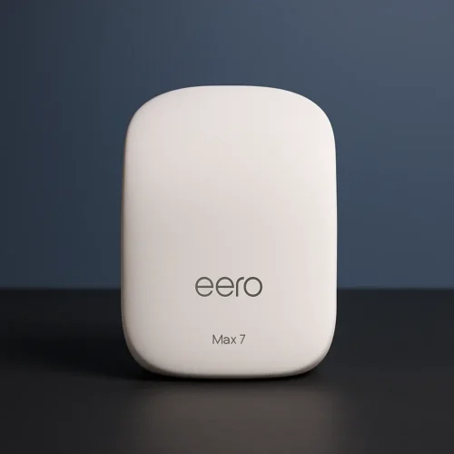 Eero Max 7 Wi-Fi 7 router in a smooth white finish with rounded corners, placed on a dark surface against a soft gradient blue background
