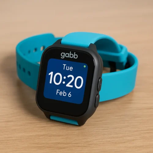 Gabb Watch 3 for kids with blue strap and dark gray casing on a wooden surface – screen showing time and date